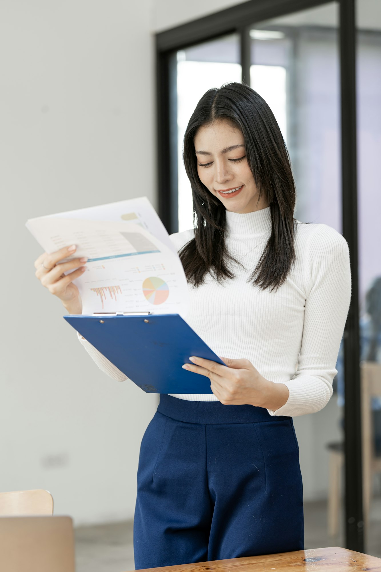 businesswoman checking on paperwork at modern office.